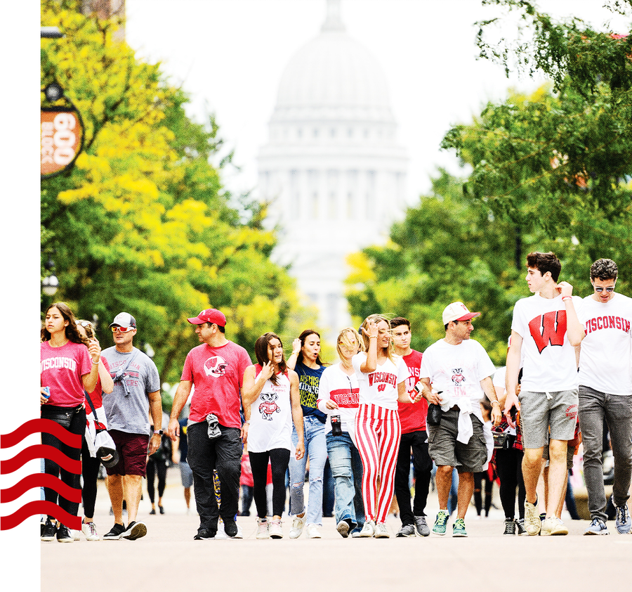 People in Badger gear in downtown Madison near the capitol